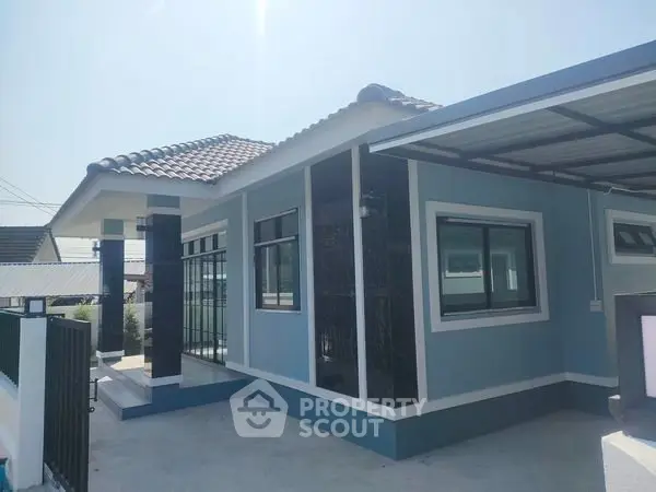Charming modern house with blue exterior and tiled roof, perfect for family living.
