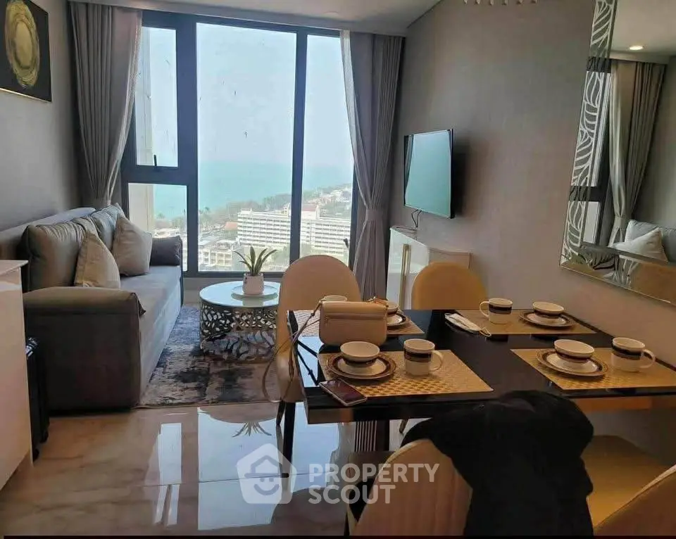Modern living room with ocean view, stylish decor, and dining area in luxury apartment.