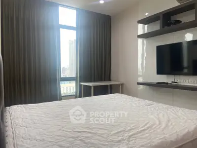 Modern bedroom with large window and city view, featuring a wall-mounted TV and sleek shelving.