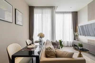 Modern living room with elegant decor and large windows for natural light.