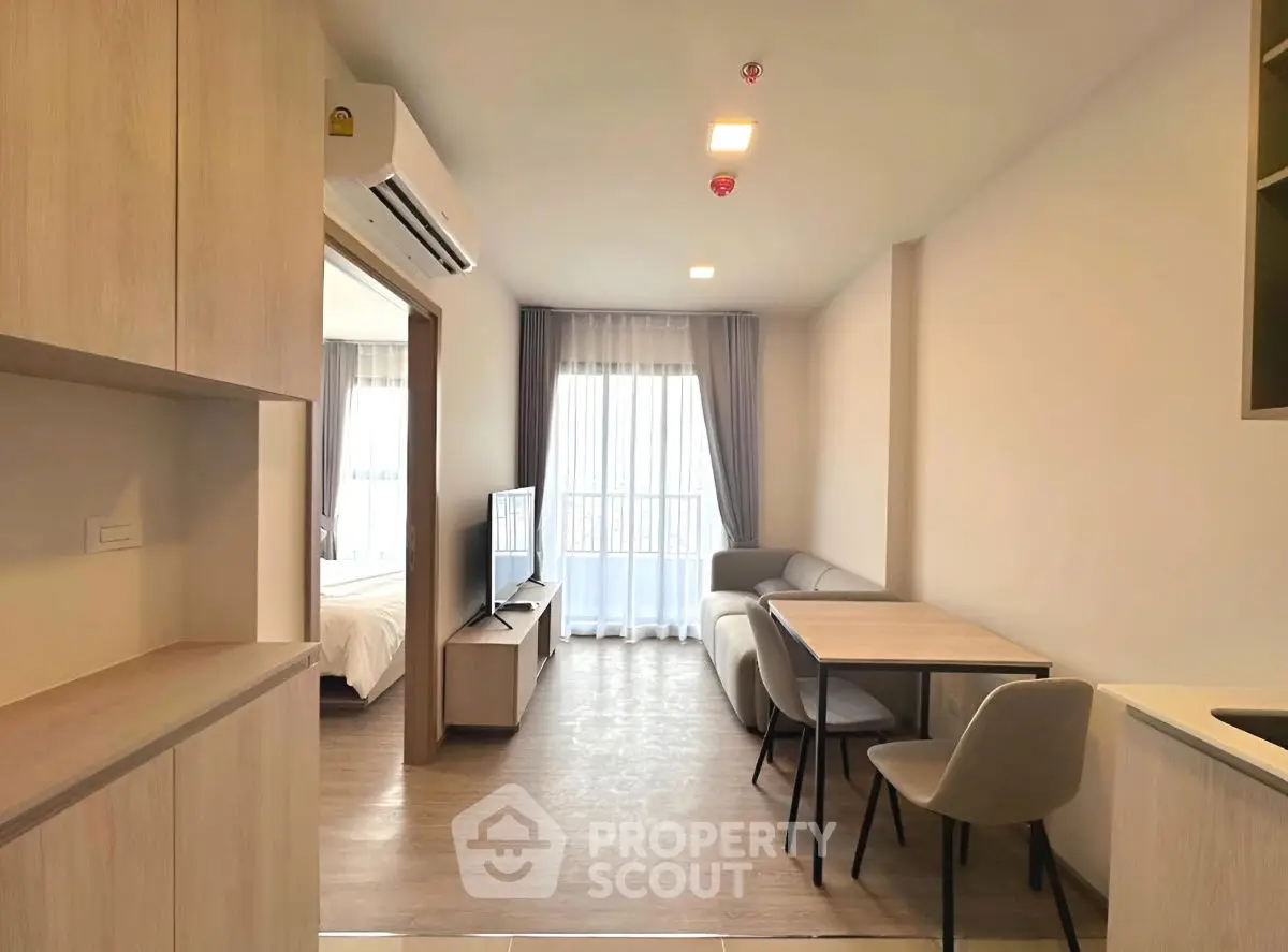 Modern open-plan living room with dining area and natural light