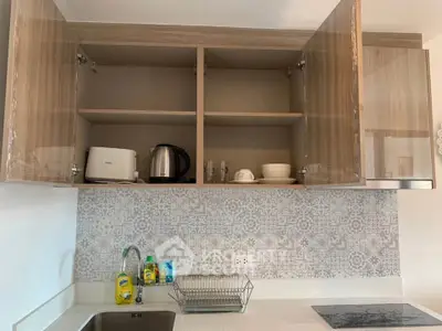 Modern kitchen with open cabinets, stylish backsplash, and sleek appliances.