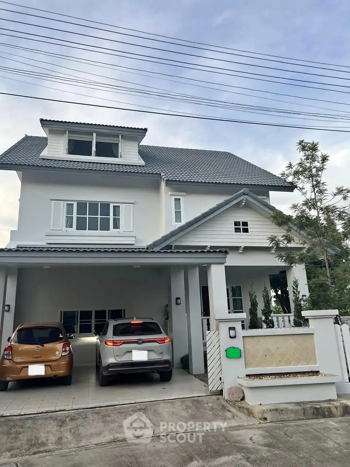 Charming two-story house with modern design and spacious driveway in a serene neighborhood.