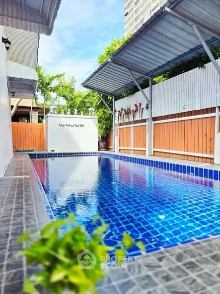 Stunning private pool with modern design and lush greenery, perfect for relaxation and entertainment.