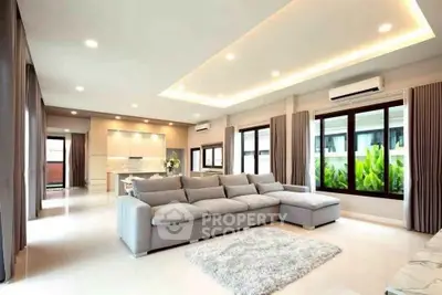 Spacious modern living room with large windows and elegant decor