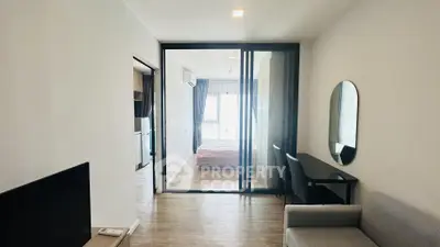 Modern apartment interior with glass partitioned bedroom and cozy living area