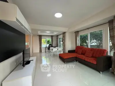 Spacious living room with modern decor and large windows for natural light