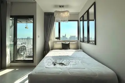 Modern bedroom with city view and elegant chandelier lighting.