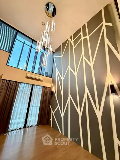 Stunning modern living room with high ceilings and unique geometric wall design