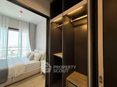 Modern bedroom with walk-in closet and large window offering a scenic view.