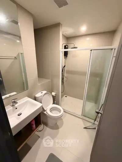 Modern bathroom with glass shower and sleek fixtures