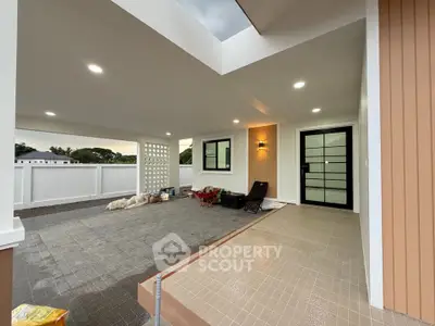 Modern covered entrance with sleek design and ambient lighting