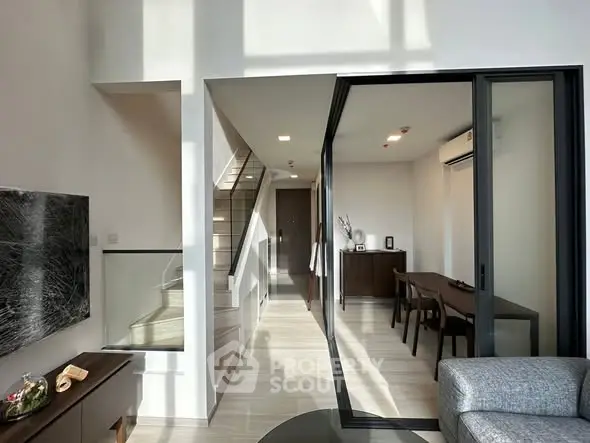 Modern living room with sleek design and abundant natural light