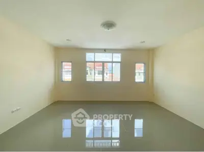 Spacious empty room with large windows and glossy tiled floor, perfect for customization.