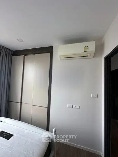 Modern bedroom with air conditioning and sleek wardrobe design