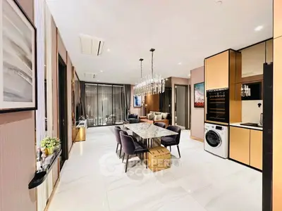 Luxurious open-plan living and dining area with modern kitchen appliances and elegant decor.