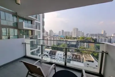 Spacious balcony with stunning city view in modern high-rise apartment