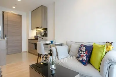 Modern living room with cozy sofa and stylish kitchen in open layout apartment.