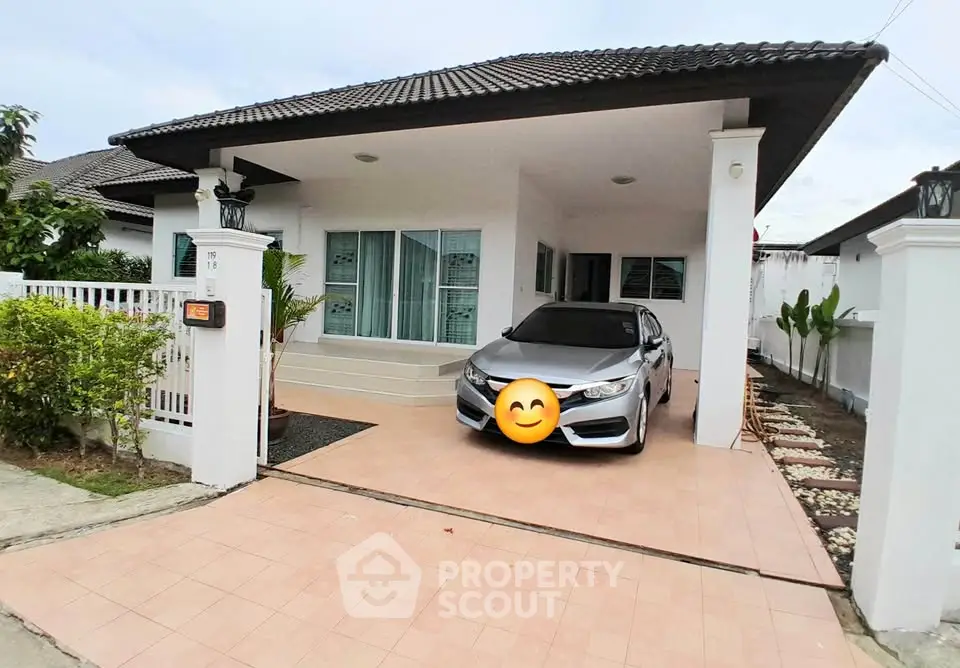 Charming single-story home with carport and tiled driveway in a serene neighborhood.