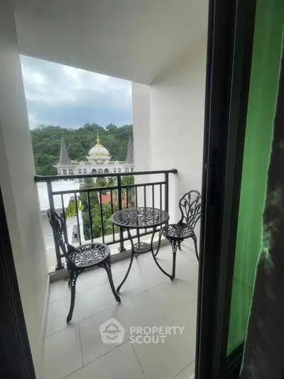 Charming balcony with elegant furniture and scenic view of architectural landmarks.