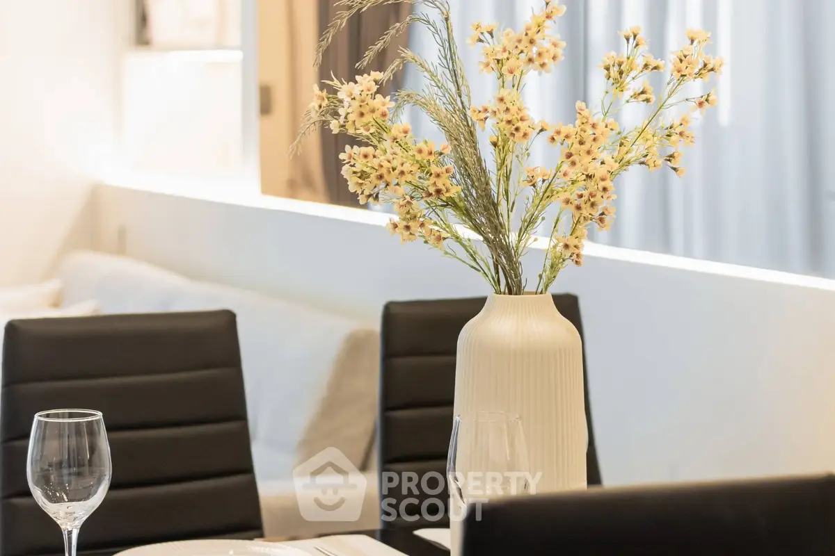 Elegant dining area with modern decor and floral centerpiece