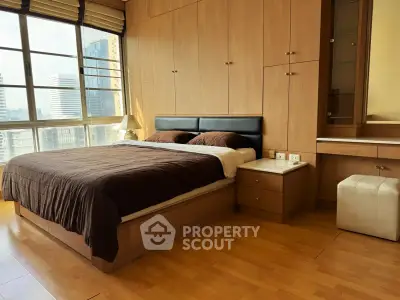 Spacious bedroom with city view, featuring wooden flooring and built-in wardrobe, perfect for urban living.