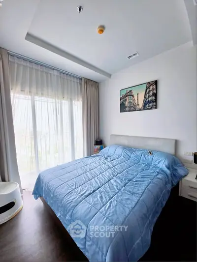 Bright bedroom with large window and modern decor