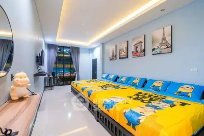 Spacious bedroom with vibrant decor and unique themed bedding, perfect for a playful and cozy atmosphere.