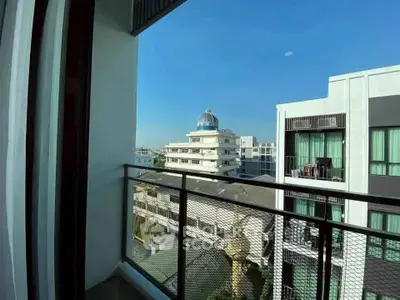 Spacious balcony with stunning city view in modern apartment building.