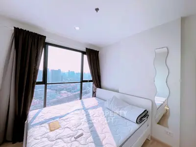Bright bedroom with city view, large window, and modern decor