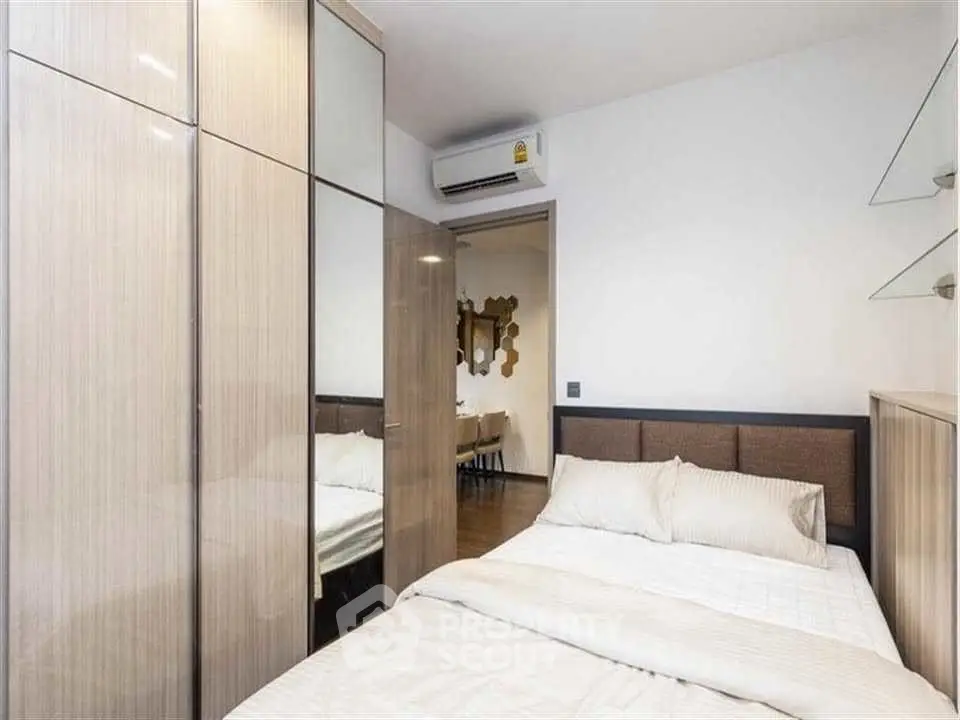 Modern bedroom with sleek wardrobe and air conditioning unit
