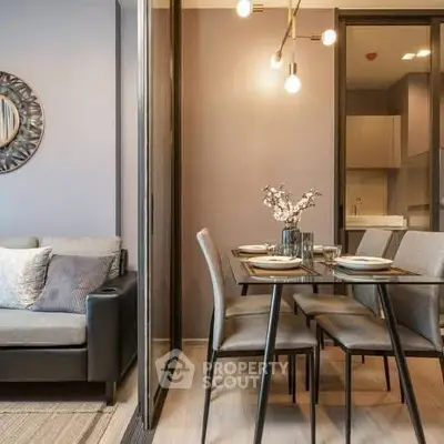 Modern dining area with elegant lighting and cozy seating in a stylish apartment.