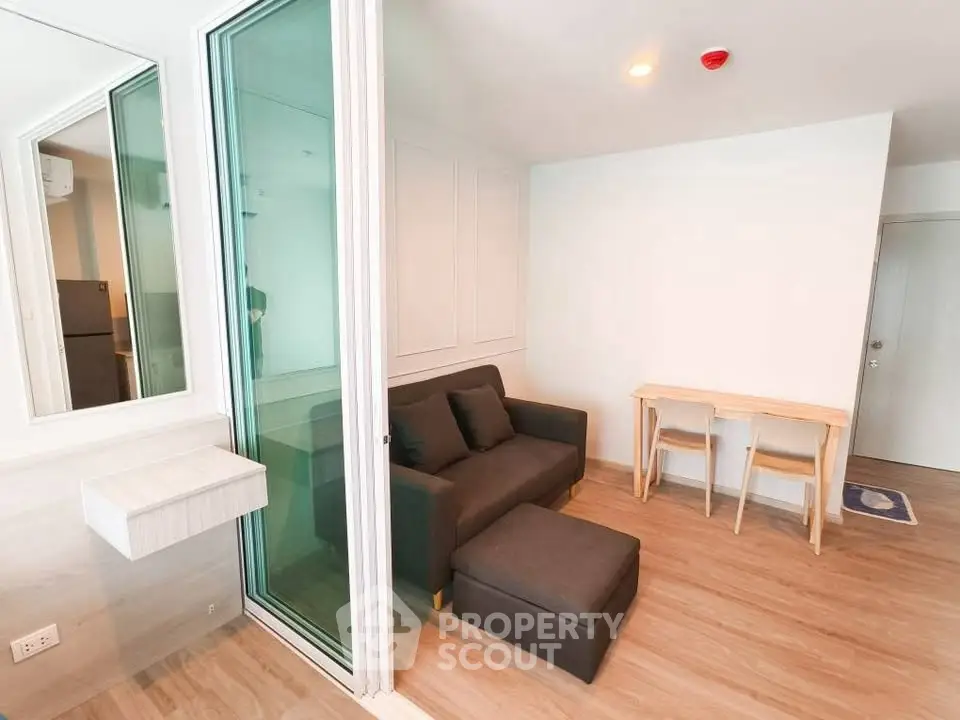 Modern living room with sleek design and cozy furniture in a bright apartment.