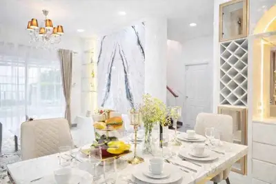 Luxurious dining room with elegant decor and natural light, perfect for entertaining guests.