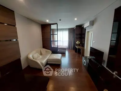 Modern living room with wooden flooring and stylish furniture in a cozy apartment.