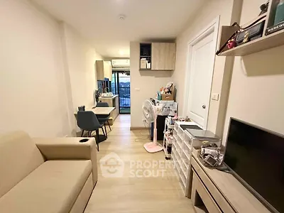Modern living room with cozy seating and dining area, featuring stylish decor and natural light.