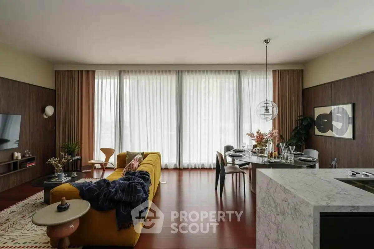 Stylish modern living room with elegant decor and open layout, featuring a cozy yellow sofa and chic dining area.