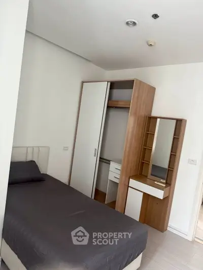 Cozy bedroom with modern wardrobe and dressing table, perfect for a minimalist lifestyle.