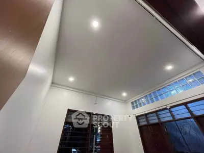 Modern interior room with recessed lighting and large windows