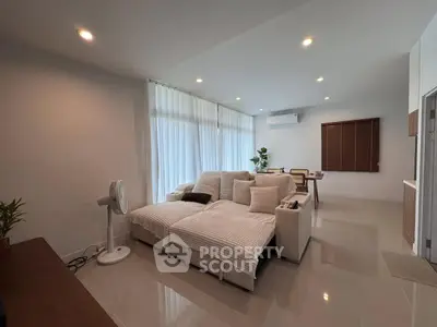 Spacious modern living room with cozy seating and natural light