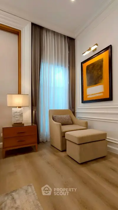 Elegant living room corner with cozy armchair and modern art decor