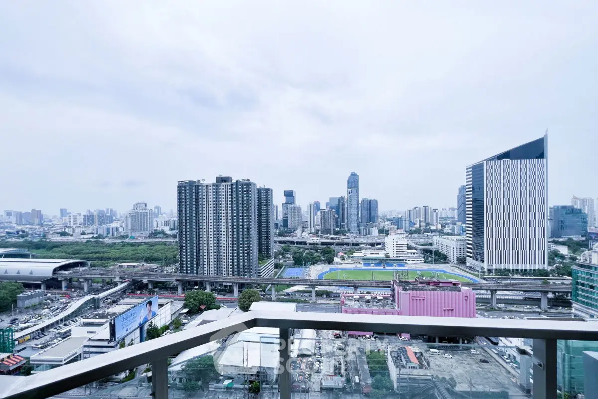 Stunning cityscape view from a high-rise balcony overlooking urban skyline.