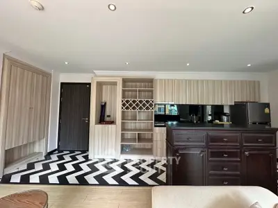 Modern living room with stylish chevron flooring and built-in shelving