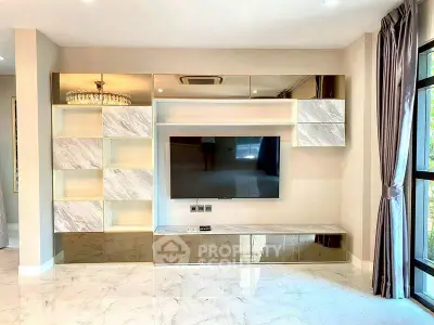Luxurious living room with modern TV unit and elegant marble flooring