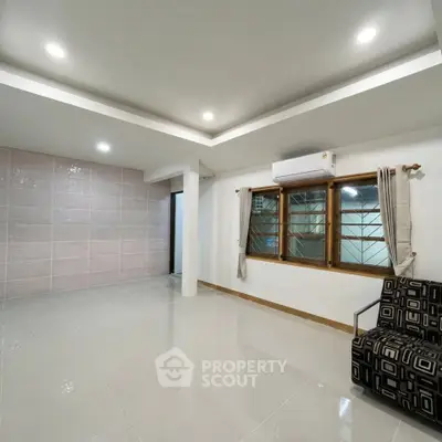Spacious living room with modern lighting and air conditioning, perfect for comfortable living.