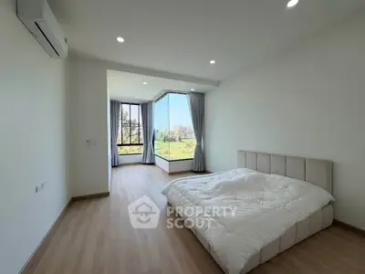 Spacious bedroom with large windows and scenic view, modern minimalist design