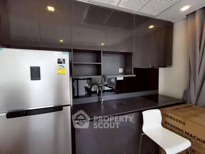 Modern kitchen with sleek cabinets and appliances, featuring a Samsung washing machine.