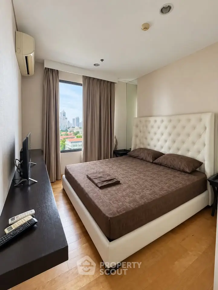 Luxurious bedroom with city view, featuring elegant decor and modern amenities for ultimate comfort.