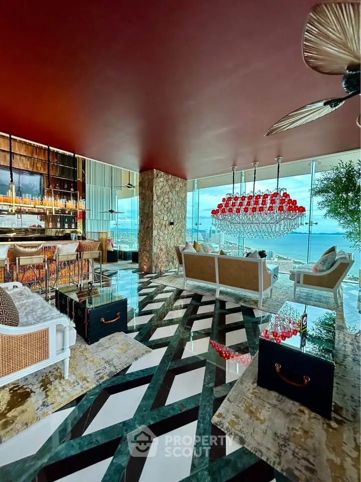 Luxurious living room with stunning ocean view, elegant decor, and modern furnishings in a high-end property.