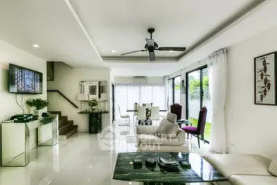 Luxurious open-plan living room with modern decor and garden view